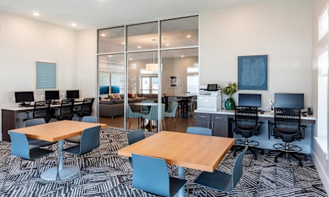 A modern office space with a large table and chairs.
