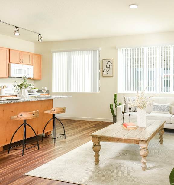 A living room with a wooden coffee table and white couches.