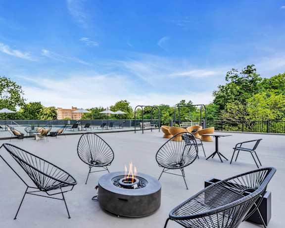 A patio with a fire pit and chairs at PREMIER @ CITY LINE, Philadelphia, Pennsylvania