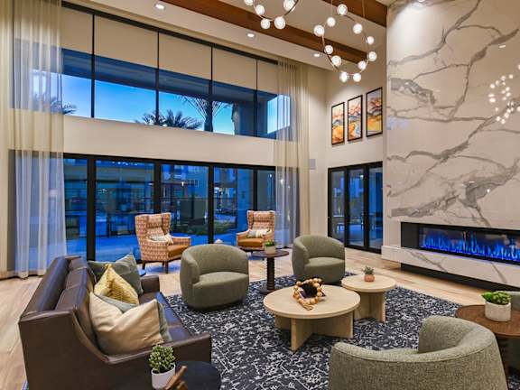 A modern living room with a fireplace and comfortable seating.