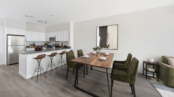 A modern kitchen with a dining table and chairs.