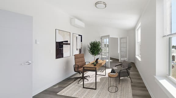 A modern living room with a grey rug and a brown chair.
