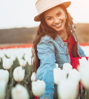 Woman in hat picking tulips