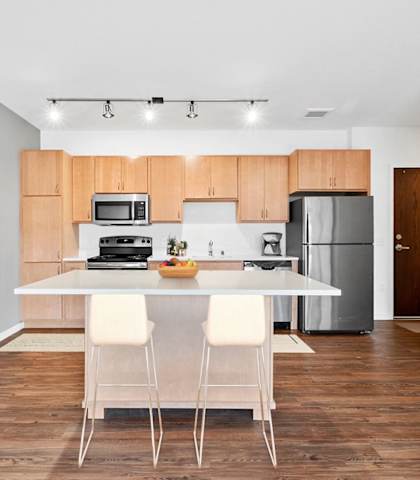 A kitchen with a table and chairs in front of it  at 1500 Nicollet Apartment Homes, Minnesota