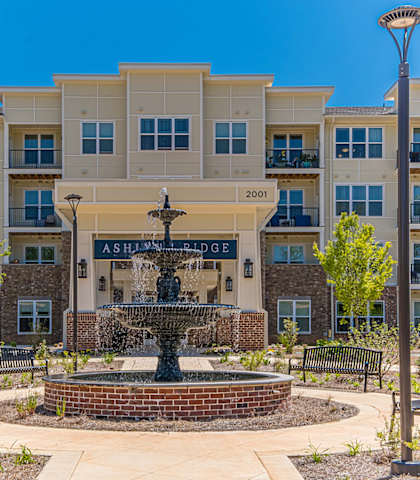 a fountain in front of an apartment building