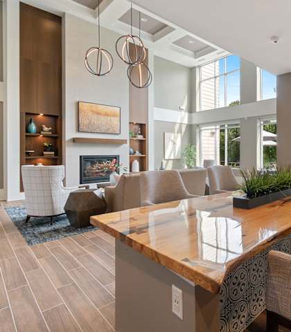 a living room with couches and a table with chairs at Oaks Landing 55+ Apartments, Minnesota, 55112