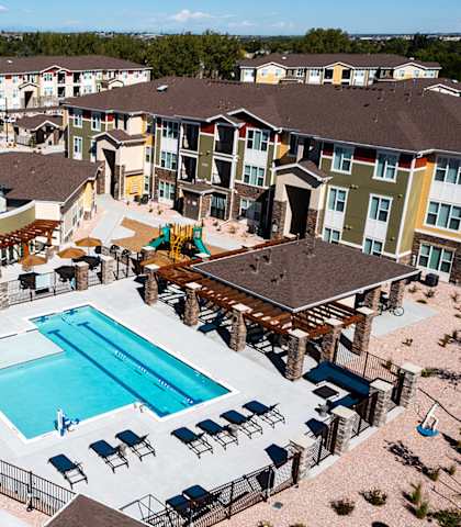 an aerial view of an apartment complex with a swimming pool