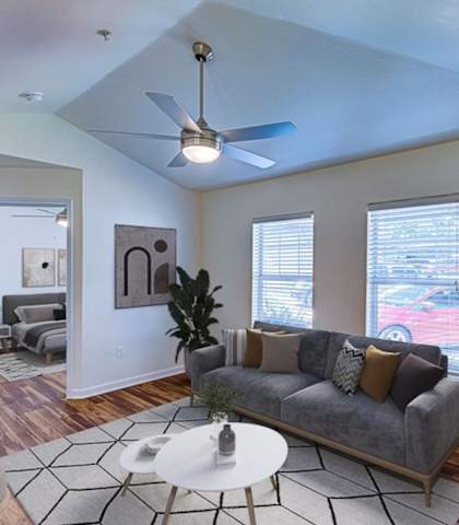 A living room with a grey couch and a white coffee table.