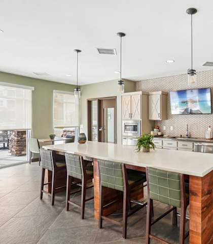 A modern kitchen with a large island and stainless steel appliances.