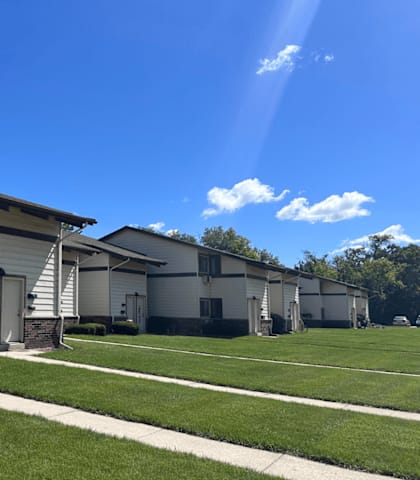 A row of houses with a clear blue sky above them.