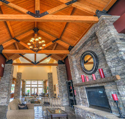 a large living room with a fireplace and a wooden ceiling at Madison Sierra Sun, Washington