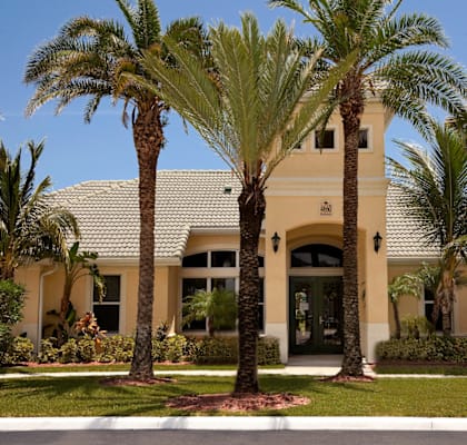 a home with palm trees in front of it