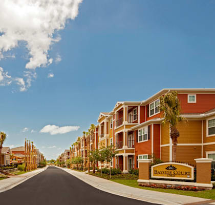 an empty street with rows of houses on either side