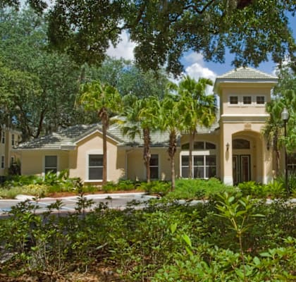 a mansion with trees in front of it