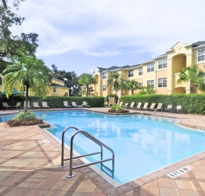 a large swimming pool in front of an apartment building