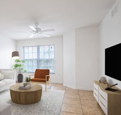 A living room with a white couch, a wooden coffee table, and a ceiling fan.