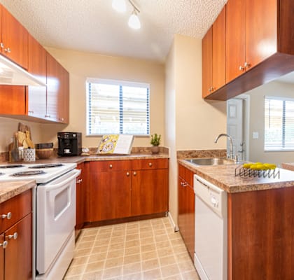 A kitchen with wooden cabinets and a white refrigerator.