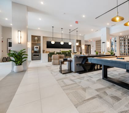 A spacious office lobby with a large table and chairs.