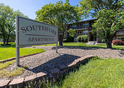 Exterior view of the Southfork Apartments clubhouse with surrounding greenery.