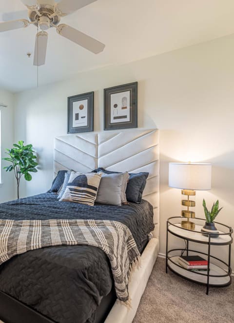 a bedroom with a bed and a ceiling fan at Mission at Baytown, Texas