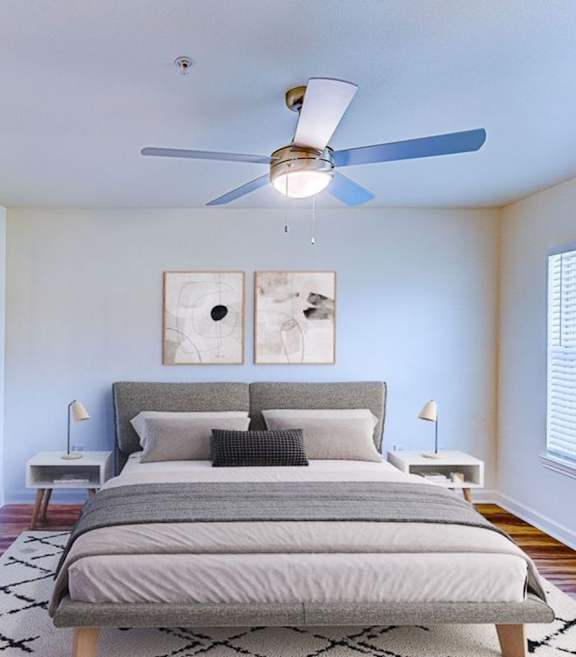 Two twin beds with blue and beige comforters in a room with white walls.
