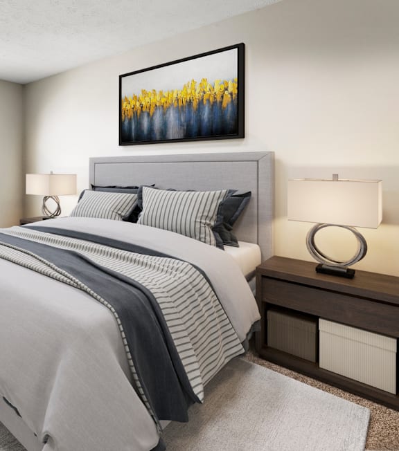 A bedroom with a large bed and a chair at Pines at Lawrenceville Apartments in Georgia, 30033