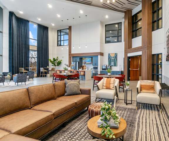 a living room with couches and chairs and a fireplace at The Bluffs at Nine Mile Creek, Minnesota