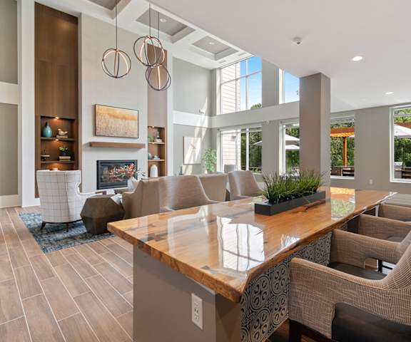 a living room with couches and a table with chairs at Oaks Landing 55+ Apartments, Minnesota, 55112