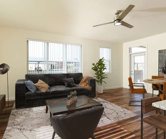 a living room with a couch and a table and a ceiling fan