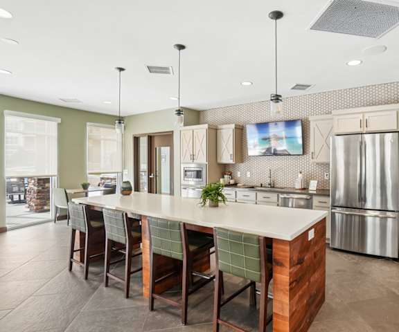 A modern kitchen with a large island and stainless steel appliances.