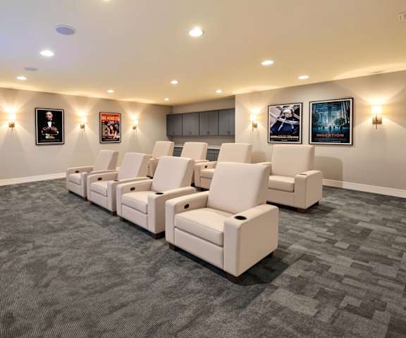 A row of white chairs are lined up in a room.