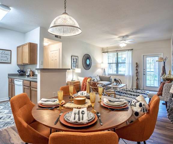 a dining room and living room with a table and chairsat Stoneridge Apartments, Pflugerville Texas