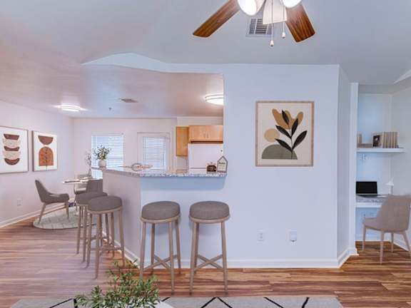 A kitchen with wooden floors and a granite countertop.