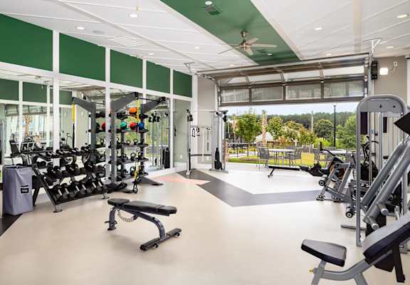 Fitness Center with the garage door open leading to patio seating outside at Carmel Vista, Georgia, 30253