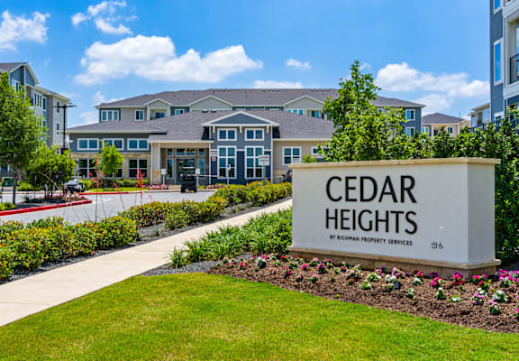 A sign that says Cedar Heights in front of a building.