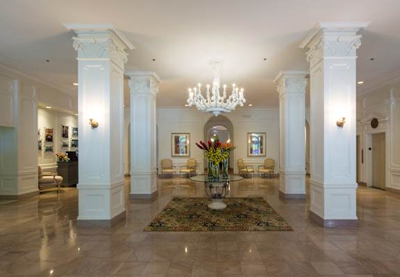 a lobby with white columns and a chandelier at Residences at Forest Park, Saint Louis, 63108