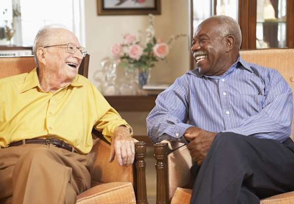 Two men sitting in chairs at KLIMPEL MANOR Apartments, Fullerton, CA