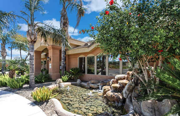 A house with a waterfall in front of it. at Superstition Canyon Apartments, Arizona