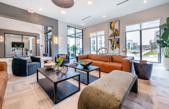 A modern living room with a black coffee table and a large window.
