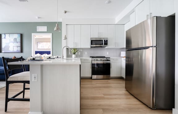A modern kitchen with a stainless steel refrigerator.