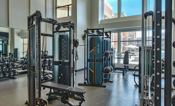 a gym with weights and cardio equipment in a building at The Apex at CityPlace, Overland Park, 66210