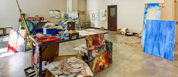 A room full of art supplies and canvases.