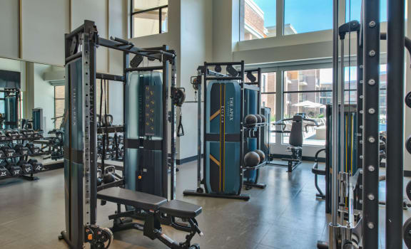 a gym with weights and cardio equipment in a building at The Apex at CityPlace, Overland Park, 66210
