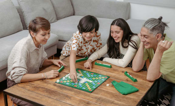a group of people sitting around a table playing a game