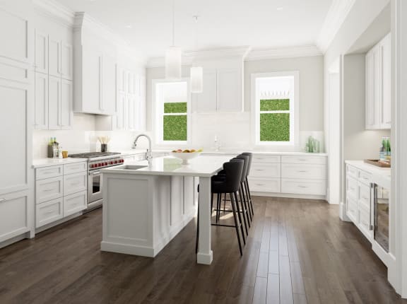 a large white kitchen with a center island and black chairs