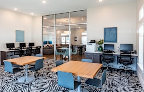 A modern office space with a large table and chairs.