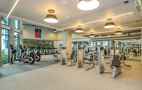 A gym with a variety of exercise equipment.