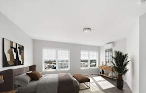 A bedroom with a large bed and a view of the city.