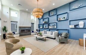 A modern living room with a fireplace and a large chandelier.