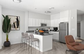 A modern kitchen with a large island and stainless steel appliances.